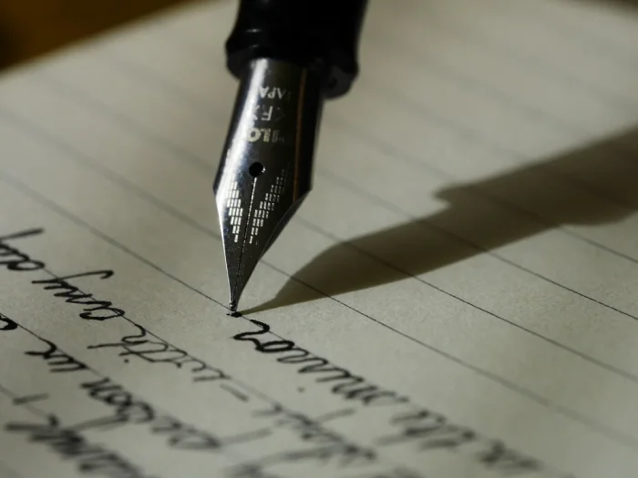 Author writing a manuscript at a desk