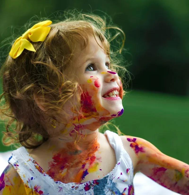Child exploring colorful creative play